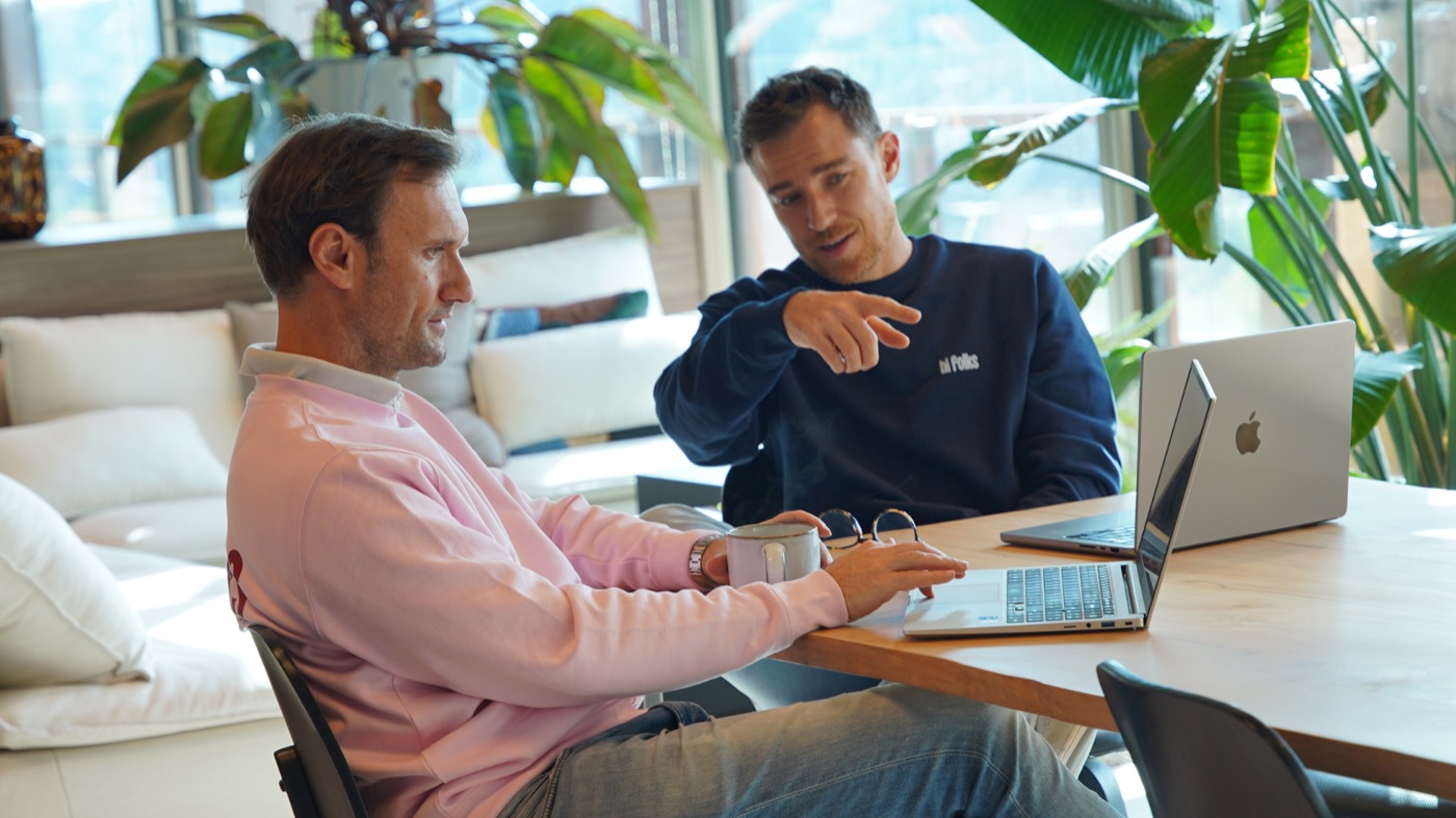 Two Hi Folks operators reviewing a build on a laptop